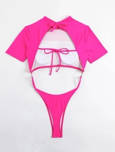 Macro view of hot pink cutout one-piece swimsuit featuring metal rings and tie-back detail