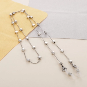 Detailed view of silver stainless steel eyewear chain with polished star charms and lobster clasps