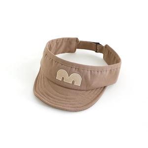 Detail of brown sun visor with beige M embroidery and adjustable buckle