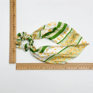 French bow hair tie with green stripes and yellow floral print on silk texture fabric