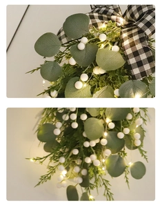 Close-up of Christmas eucalyptus swag with white berries, pine needles and LED lights