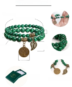 Detailed view of 6mm and 8mm malachite bead bracelets with a tree of life charm and gift box