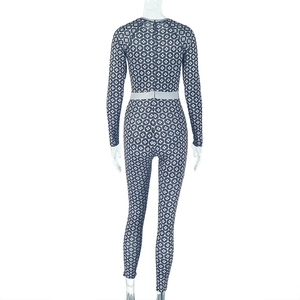 Rear view of long sleeve slim fit jumpsuit with blue and grey geometric dot patterns