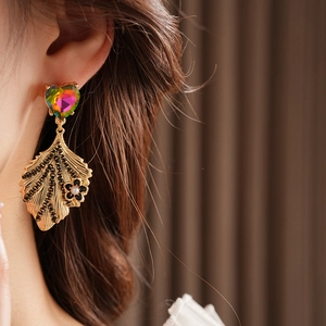 Detail of vintage heart earring with gold leaf, black diamonds and pearl accents