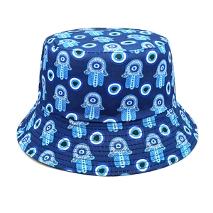 Detailed close-up of blue bucket hat with Hamsa Hand and Evil Eye pattern and stitching