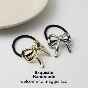Close-up of high-gloss gold and silver alloy bow hair ties on black elastic bands