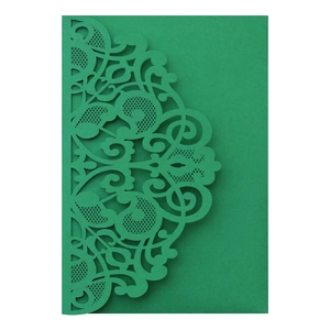 Detail showing the green laser-cut floral lace pattern on an elegant invitation card