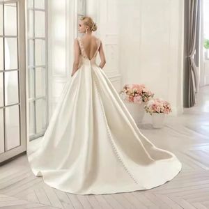 Elegant ivory satin wedding dress with deep V-back, lace embroidery, and cathedral train