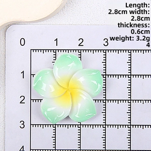 Detailed view of 2.8cm resin plumeria flower on a measurement grid for DIY hair accessories