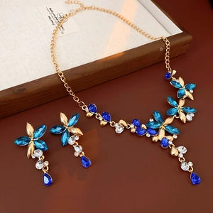 Close-up of vintage flower and teardrop jewelry set with blue and white crystals