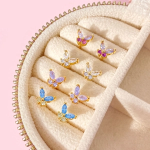 Macro detail of colorful butterfly earrings with zircon stones in a plush jewelry box