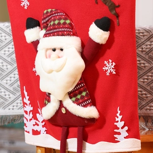 Close-up of red Christmas chair cover featuring Santa Claus with plaid hat and wood button