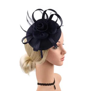 Detail of navy blue fascinator with large floral fabric rose and elegant long feathers