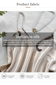 Close-up of leopard trim silk pajama set with pearl necklace on elegant white fabric
