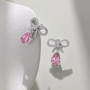 Close-up of S925 silver bow earrings with pink pear-cut zircon water drop pendants