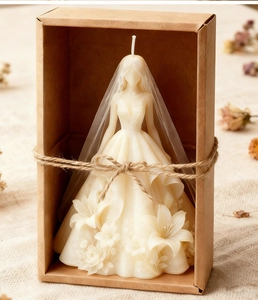Detailed wedding dress candle mold showing intricate floral relief in a gift box