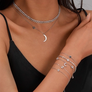 Detail view of 925 sterling silver bracelets featuring zircon stars and letter charms