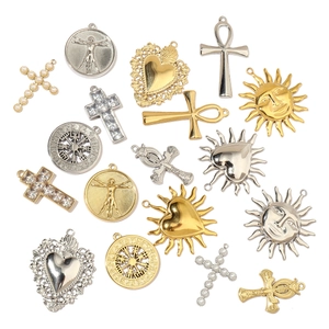 Detailed assortment of golden and silver steel pendants with cross and sun motifs