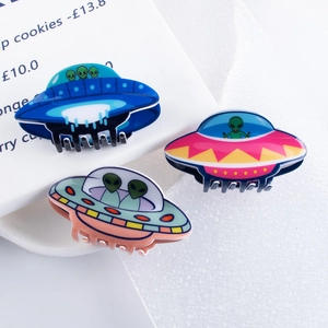 Three-piece alien UFO hair claw set in blue, pink, and taupe with polished finish