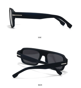 Detail view of matte black sunglasses with silver metal T-accents on the side and back