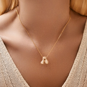 Classic gold-plated necklace with a zircon-inlaid pendant worn on a model neckline