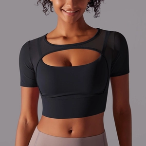 Detail of black yoga top featuring sheer mesh patchwork and front oval cutout design