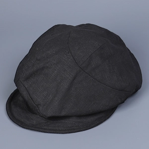 Detail view of the breathable linen fabric texture and stitching on a black newsboy cap