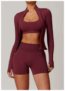 Detail of burgundy seamless yoga jacket featuring stand collar and thumbhole cuffs