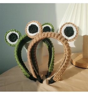 Detailed close-up of handmade knitted frog headbands with cute eyes and non-slip inner teeth