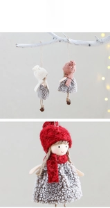 Detailed view of handmade Christmas plush dolls with wool skirts and bronze bells
