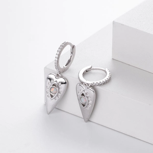 Detail of silver heart earring with opal eye and white zircon pavé on geometric stand