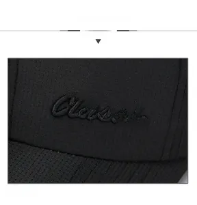 Macro shot of black twill baseball cap showing detailed Classic letter embroidery