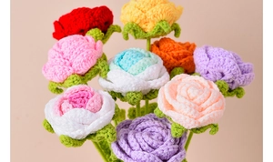 Detail showing colorful handmade crochet rose flowers with soft yarn texture and green sepals