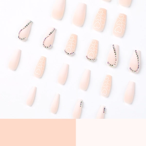 Matte pink gradient coffin press-on nails set with heart patterns and rhinestones