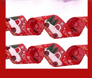 Detail of red Christmas ribbon featuring printed white trucks and green trees for DIY decor