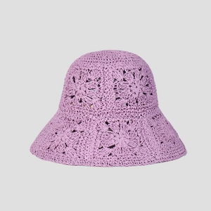 Detail of purple handmade crochet straw hat with hollow floral texture and wavy brim