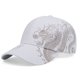 Detail of white cotton baseball cap featuring gray Chinese dragon prints on the side