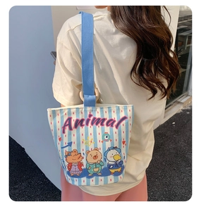 Lifestyle view showing the canvas bucket bag size and blue striped animal print design
