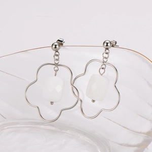 Elegant silver flower earrings with white square gem drop on glass rim, minimalist design