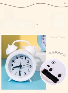 Detail of silent quartz movement mechanism and battery compartment on white alarm clock