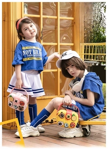 Outdoor shot of children carrying colorful EVA cartoon crossbody bags with 3D charms