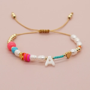 Adjustable colorful bead bracelet featuring pearls, gold stars, and heart with letter A
