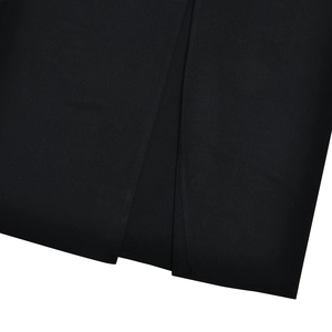 Macro detail of the fabric texture and side seam stitching of this black slim-fit dress