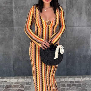 Detail showing wave-pattern knit fabric and V-neckline with ring clasp on a long dress