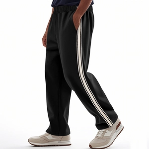 Detail view of men's straight-leg sports pants with white side stripes and drawstring waist