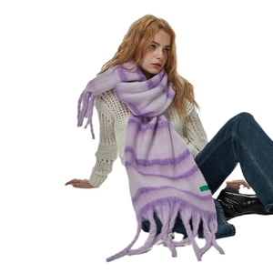 Soft purple striped plush scarf with fringes on a model for winter warmth and style