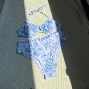 Two-piece floral print bikini with halter neck top and high-waisted ruffled bottoms