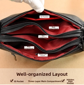Internal view of leather bag with red herringbone lining and multi-compartment storage