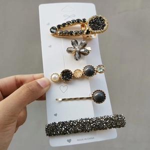 Detailed view of a 5-piece candy-colored hair clip set with pearls and rhinestones