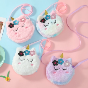 Detail view of colorful plush unicorn shoulder bags with glitter horn and flower accents